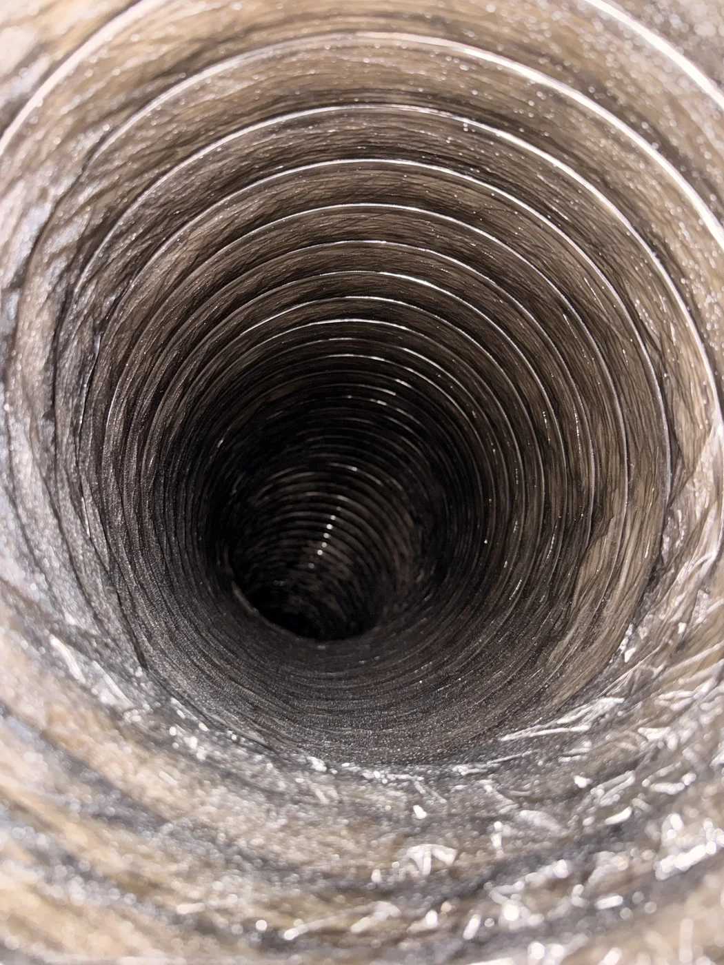 Flexible HVAC duct interior photographed while cleaning was still in progress
