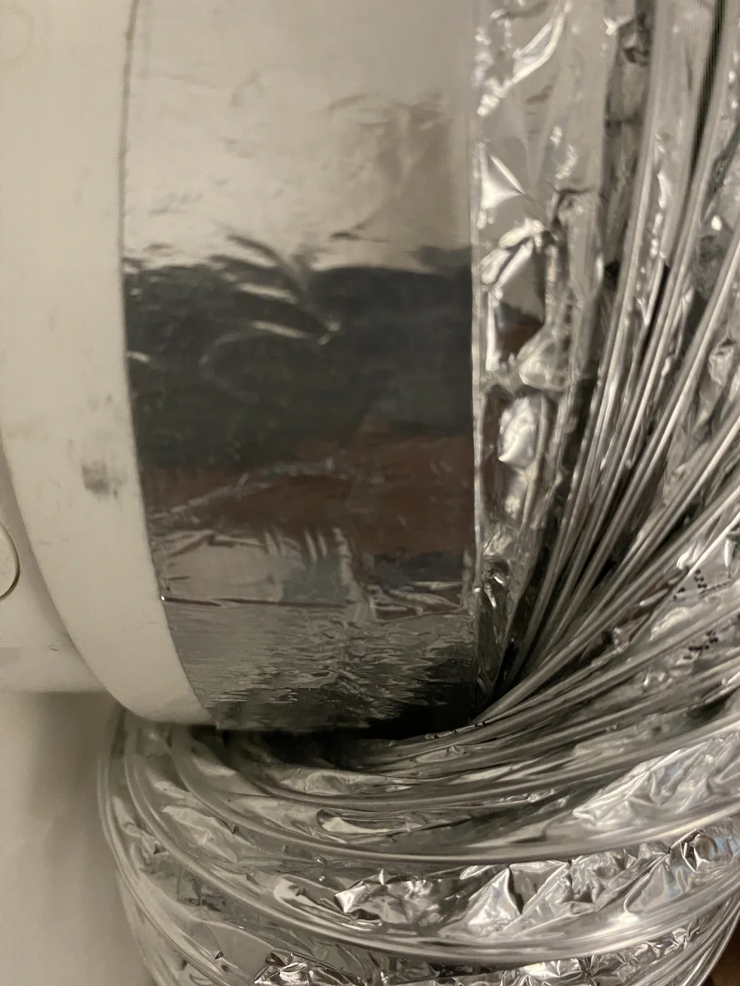 Flexible foil dryer duct connected to a taped metal elbow