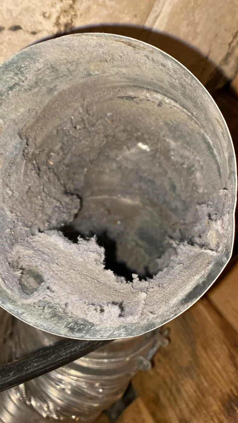 Round metal dryer exhaust duct with heavy lint accumulation