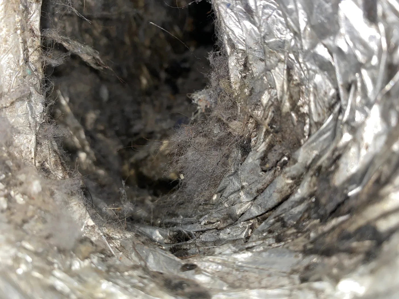 Lint and debris along the interior surface of a flexible foil dryer duct